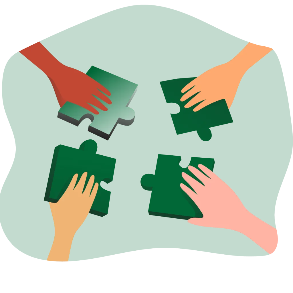 Four hands reach toward interlocking puzzle pieces on a green surface